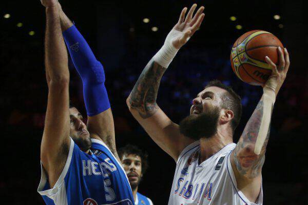 Serbia's Miroslav Raduljica, right, shoots over Greece's Giannis Bourousis during their Basketball World Cup Round of 16 match in Madrid, Spain, Sunday, Sept. 7, 2014. The 2014 Basketball World Cup competition will take place in various cities in Spain from Aug. 30 through to Sept. 14. (AP Photo/Andres Kudacki)