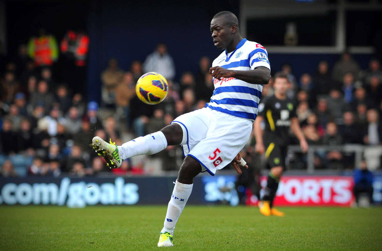 Queens Park Rangers' newly signed Congolese defender Christopher Samba gestures during the English Premier League football match between QPR and Norwich City at Loftus Road in London on February 2, 2013. AFP PHOTO/CARL COURT == RESTRICTED TO EDITORIAL USE. No use with unauthorized audio, video, data, fixture lists, club/league logos or â??liveâ? services. Online in-match use limited to 45 images, no video emulation. No use in betting, games or single club/league/player publications == (Photo credit should read CARL COURT/AFP/Getty Images)