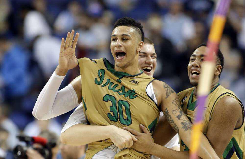 Notre Dame's Zach Auguste (30) celebrates with teammates after an NCAA college basketball game against North Carolina in the championship of the Atlantic Coast Conference tournament Saturday, March 14, 2015, in Greensboro, N.C. Notre Dame won 90-82. (AP Photo/Bob Leverone)